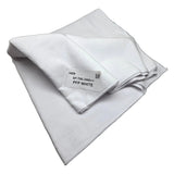 A folded white microfiber cloth with a white paper label that reads 'Spilda SP-TWL3060++ PFP WHITE', displayed on a neutral gray surface.